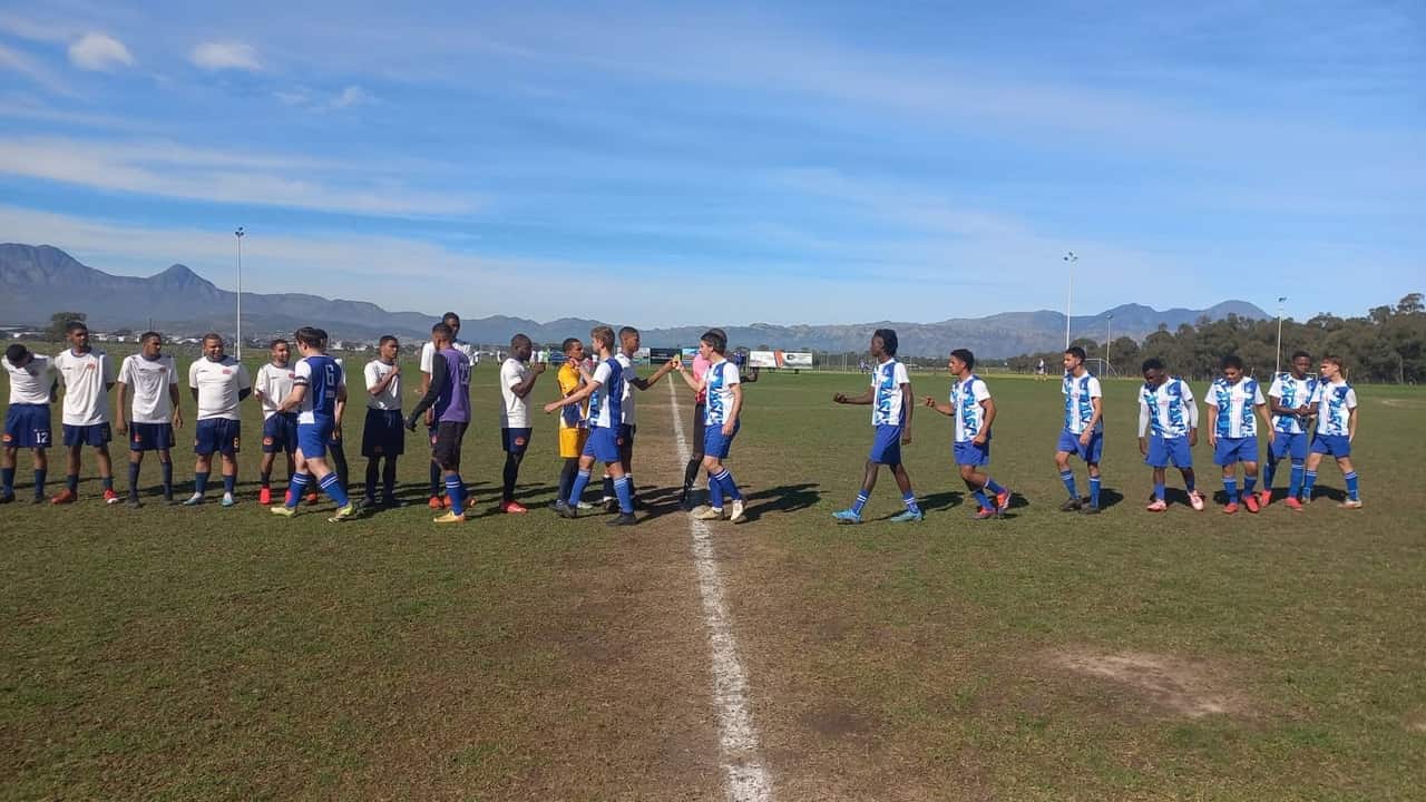 De Beers AFC players shaking hands with the opposition on the halfway line before kickoff