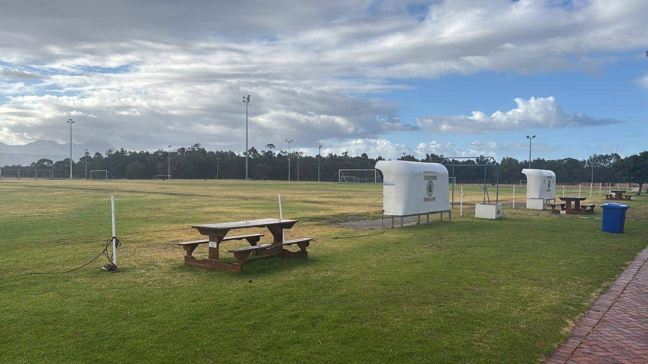 The De Beers AFC ground, with the dugouts and the Helderberg mountains behind