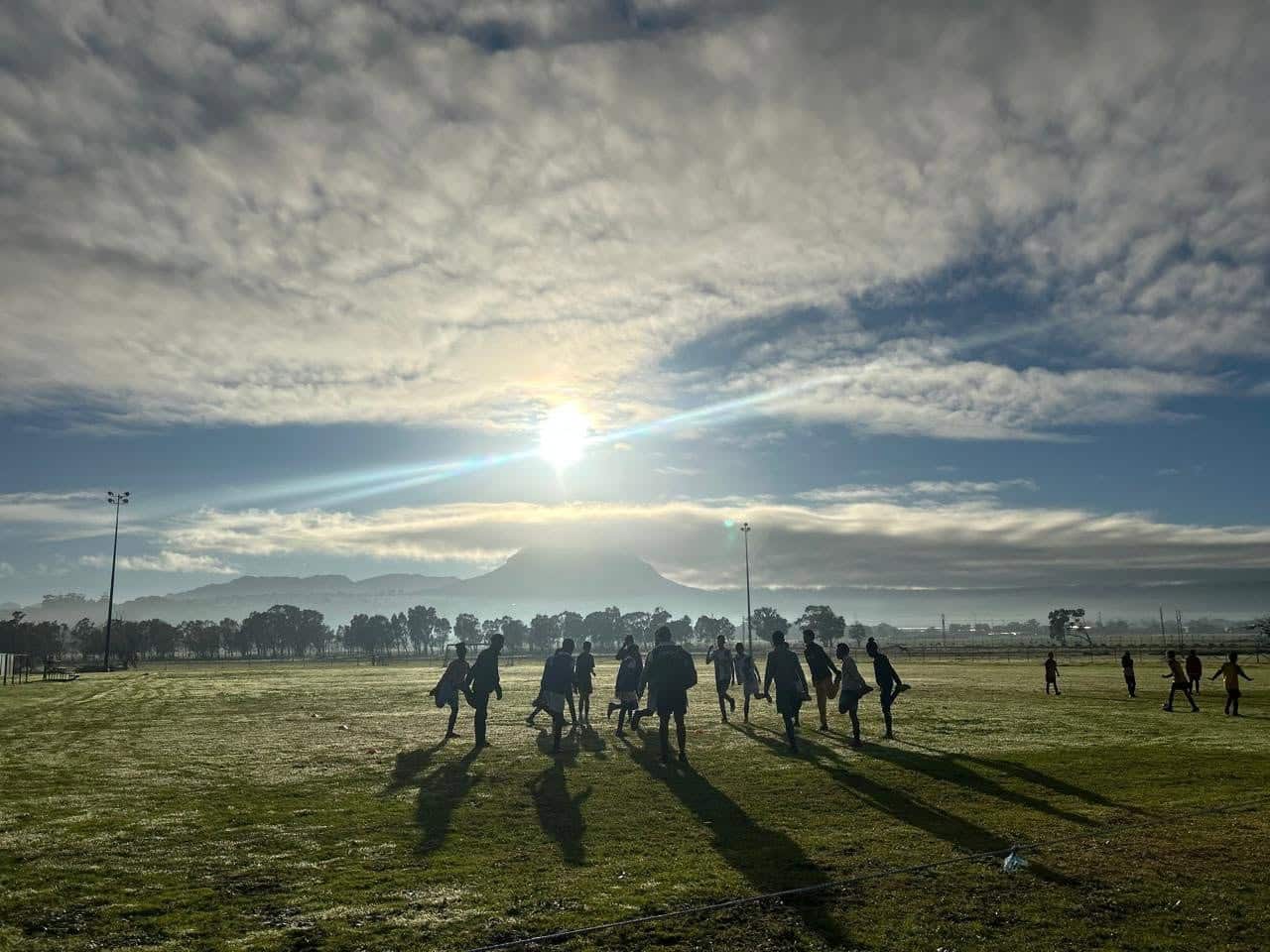 De Beers AFC players warming up at the club ground at sunrise